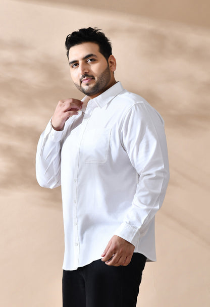 Man wearing a white shirt against a beige background