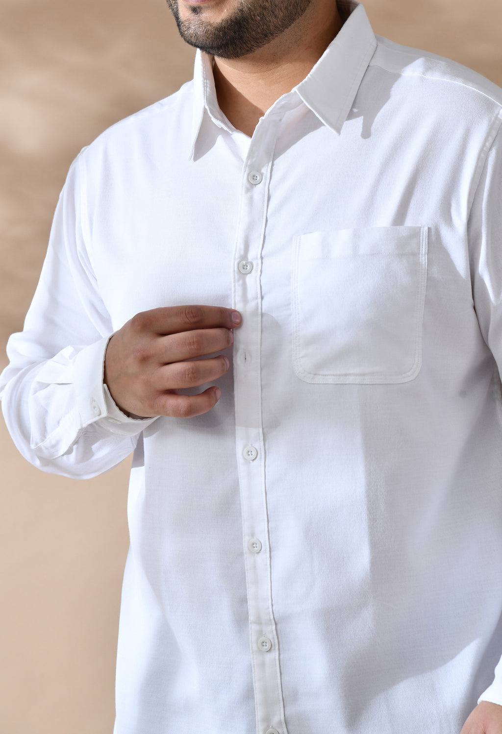 White shirt with a pocket on a beige background